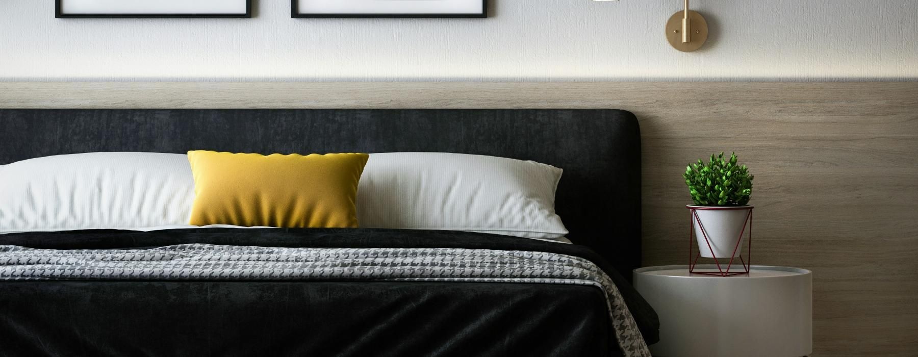 a bed with a black pillow and white pillows