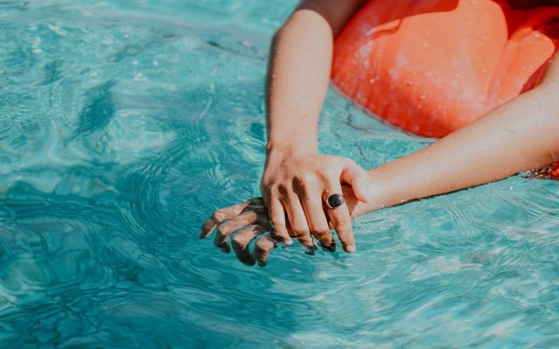 a person's hands in the water