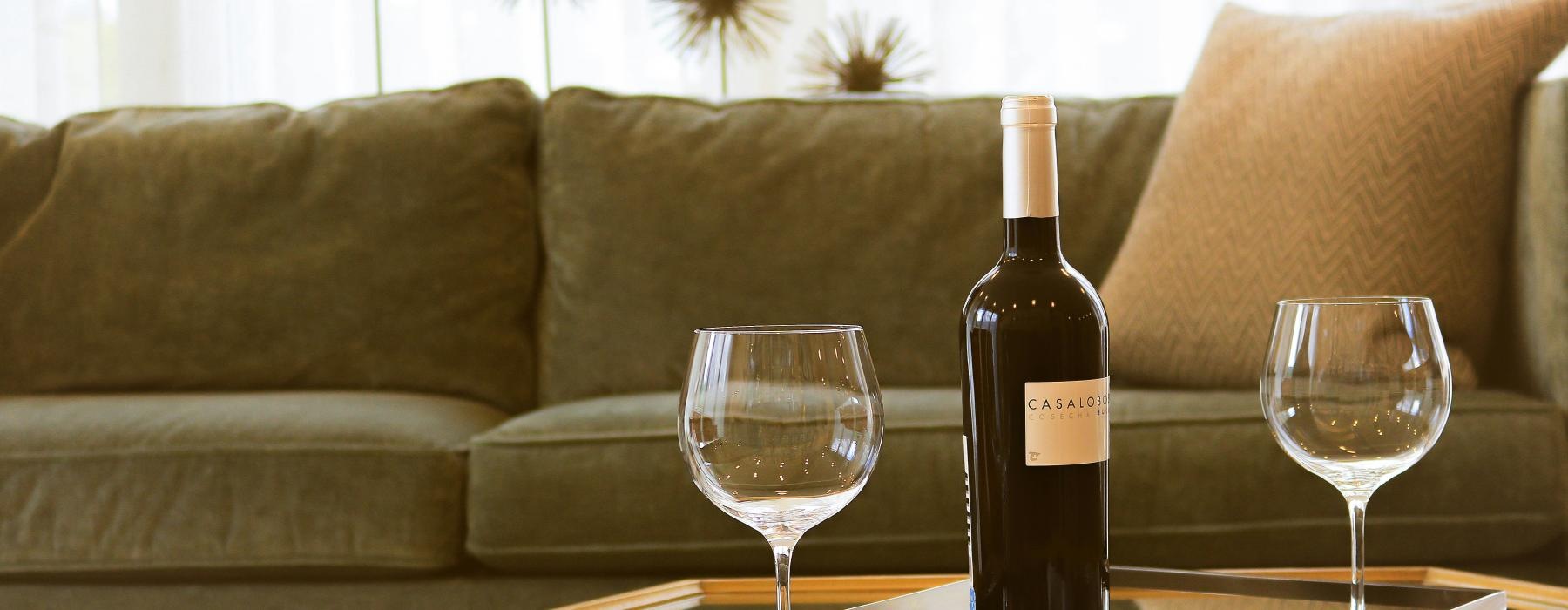 a bottle of wine and glasses on a table