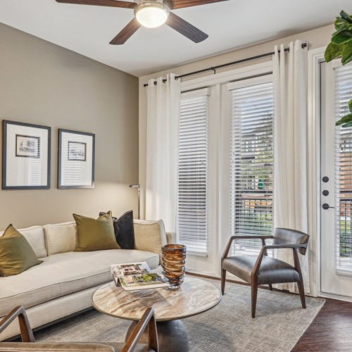 Relax and unwind in well-lit living areas urban apartments for rent with ceiling fan and large windows